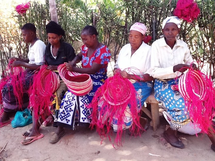 Women weavers in Kitui, Kenya constructing baskets destined for Walmart.