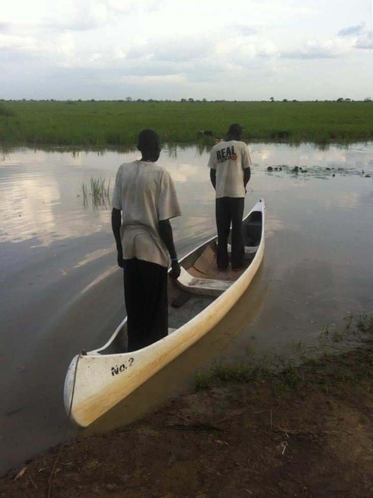 Two South Sudanese fishermen set out in a USAID-provided canoe to bring fish and much-needed goods back to their communities.