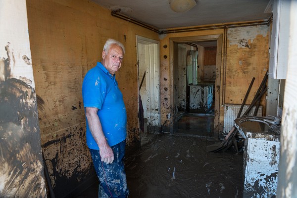Man cleans mud from his home after devastating floods of May 2014 in Maglaj, BiH.