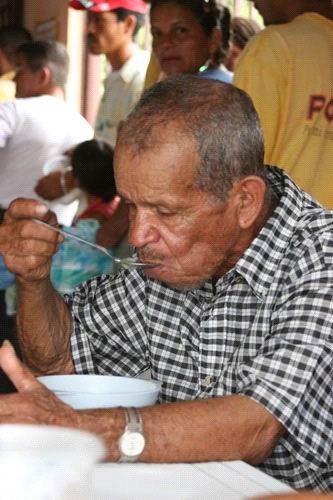A man eating soup at an assistance center