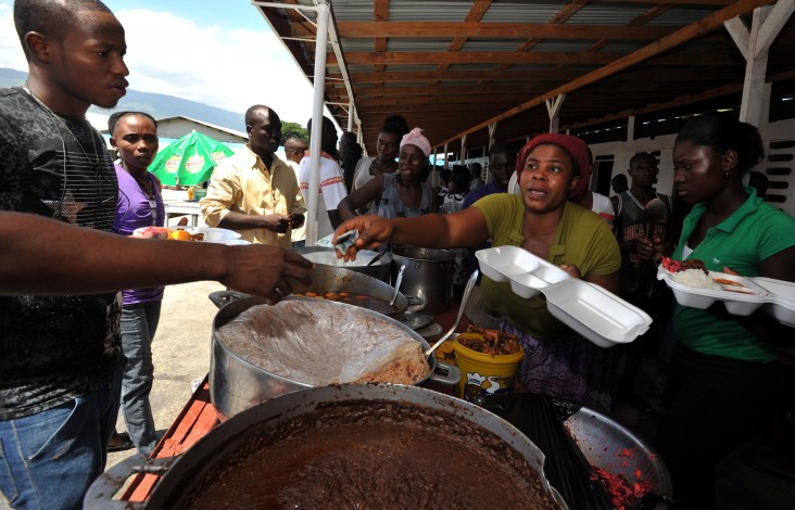 A vendor dishes out meals at an industrial park in Port-au-Prince, Haiti. 