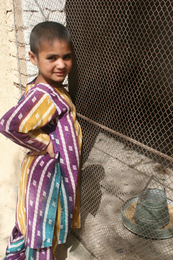 A girl in Mastung District stands by her family’s new chicken coop, where the chickens stay to beat the midday heat.