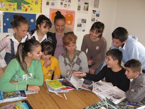 Teaching from a wheelchair at home in Tirana, Teuta Halilaj (center) inspires her students with her positive attitude.
