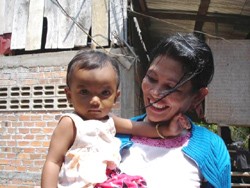 Phally plays with her niece in Battagram, western Cambodia. After her husband died of HIV/AIDS, Phally learned that she too was 