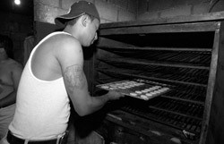 Omar and another former gang member work in a machine shop in Guatemala City. 