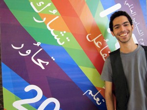 Al Zaghal stands beside his winning poster. 