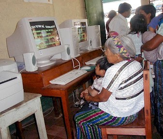 Community members use computers at the rural school in Cunén, Quiché , Guatemala.  