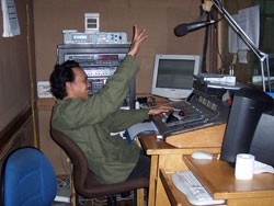 Radio News 68H technician Joni Yohanes broadcasting news that reaches eight million men and women across Indonesia and throughou
