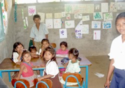 Students of the new Los Ositos Presechool, financed by increased profits from Fair Trade coffee sales, pose with their teacher