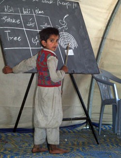 This student at a school in the Mehra Camp for displaced earthquake survivors in Pakistan leads his classmates in an English lan