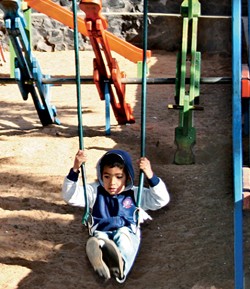 Elvio Barrios enjoys the swingset in the rebuilt playground of Ñemby’s main park.