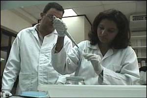 Dr. Mireya Matamoros, Director and Miguel Fortín, Analyst, at the genetics lab in the Forensic Medicine Directorate. 