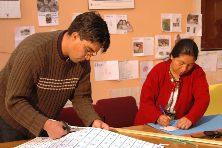 A man and woman work on the production of a domestic violence publication