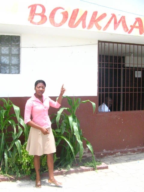 Cité Soleil resident Fabienne Viltis, standing in front of the community radio station where she hosts a show.
