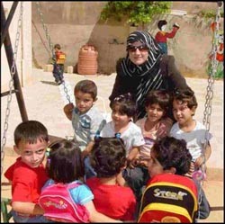 Zeinab plays with the children attending her kindergarten in Sakhra, Jordan.