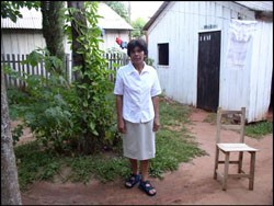 Tomasa, a local midwife, at the entrance of her house in Caaguazu. 