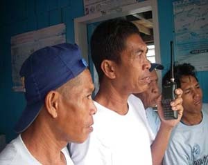 Nasirin “Kah Nas” Taraji (middle) stands guard with other members of the Kulape/Batu-Batu marine sanctuary enforcement team.