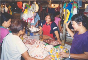 Stall owner Angelina Bulos at the Muntinlupa Market is pleased that both vendors and customers now have a cleaner market thanks 