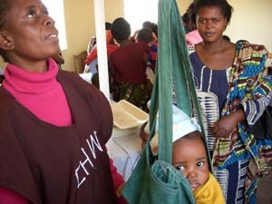 During Child Health Week in Zambia, community health volunteer Mary Kafumbe weighs Joshua Matabula