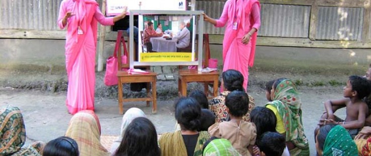 A courtyard meeting conducted by the Social Marketing Company trains expectant and new mothers on newborn care.