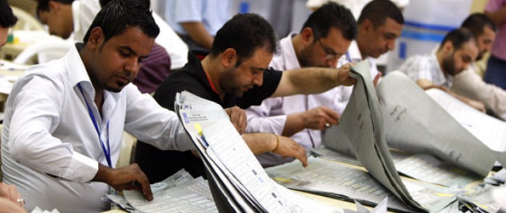 Iraqis count votes at the Independent High Electoral Commission headquarters in Baghdad on March 12, 2010.