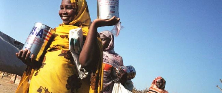 USAID foodstuffs are distributed through the World Food Program to internally displaced persons in Muhadjeria, Darfur.