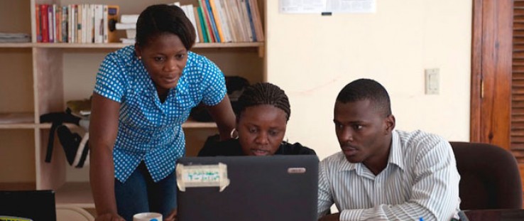 ENDK journalist Witza Petit Antoine is flanked by Internews researchers Louisena Louis, left, and Franck Lafont as they sort SMS