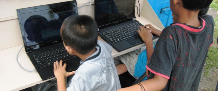Kids access the Internet in rural West Sumatra.