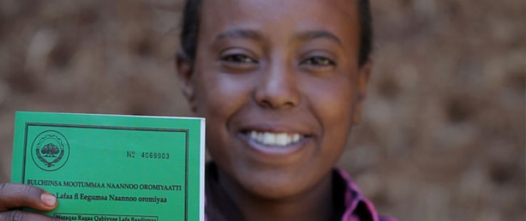 Asilya Gemmal, 14, of Gure Tebeno Union, proudly displays her land certificate obtained from the Ethiopian Government with USAID