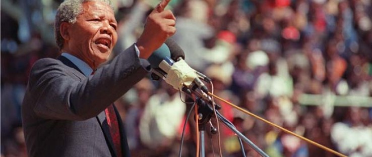 Anti-apartheid leader and African National Congress member Nelson Mandela speaks at a funeral for 12 people who died during town