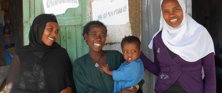 Enanit Metiku holds her son, Tazen, flanked by Belaynesh Fentie, left, and Tegegnech Tsehay, health extension workers.