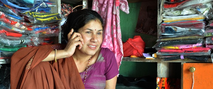 A small entrepreneur uses her mobile banking services to pay for her supplies. 