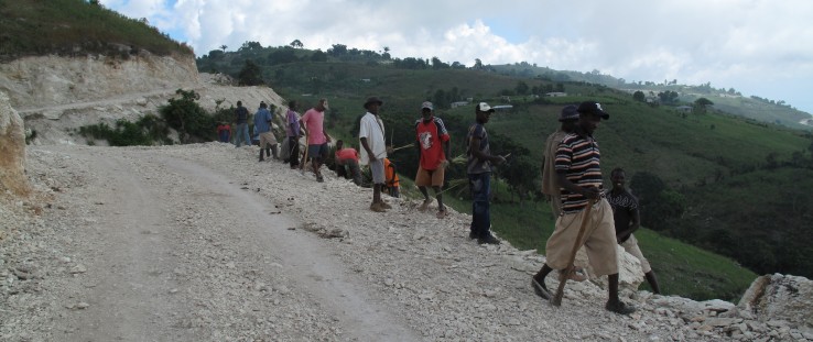 Members of the Fond Baptiste community carry out labor-intensive road maintenance. credit: Jacob Greenstein