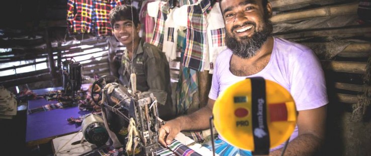 Jalal Molla with his solar lights and sewing machine