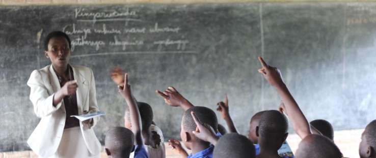 Teacher Beatha Nikuze interacts with students in her third grade classroom at Kanyinya Primary School.