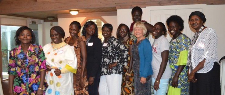 Christie Vilsack, USAID senior adviser for international education, in blue cardigan, with South Sudanese students in USAID-supp