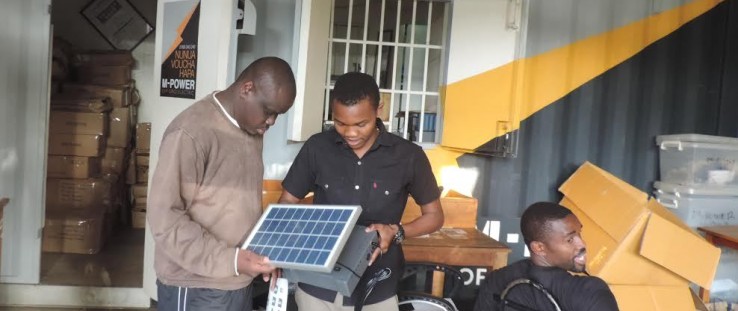 Steve Wasira, left, visits Off Grid Electric, a partner of the Power Africa sub-initiative, Beyond the Grid.