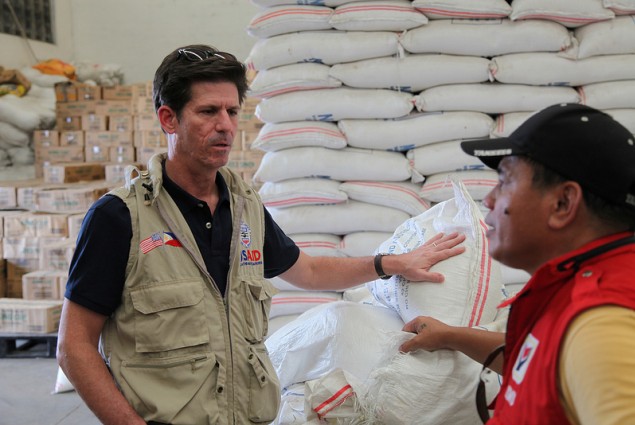 DAA Greg Beck discussing continuous relief operations with a DSWD rep