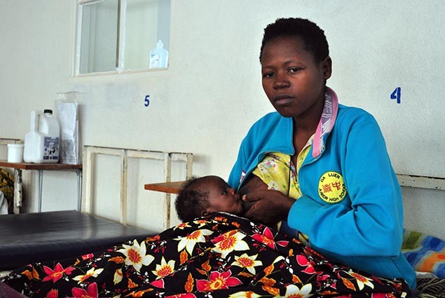 A mother nurses her child in a hospital in Rwanda