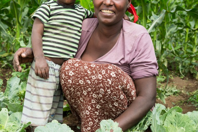 USAID beneficiary Aster Kasem and her son in their garden.