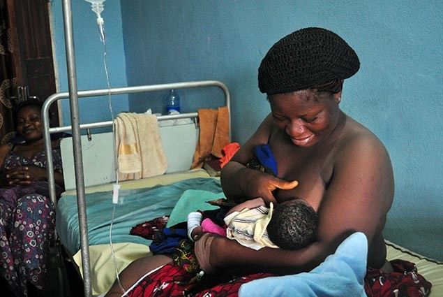 A mother nurses her newborn in a hospital in Nigeria