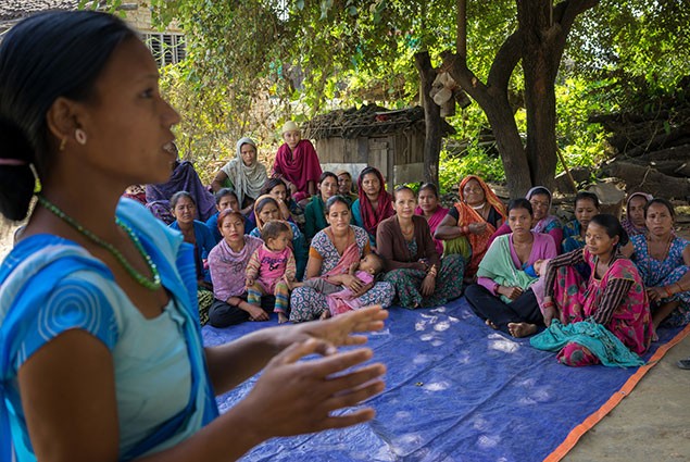 A A community health worker speaks to women about family planning
