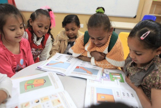A group of second grade girls focus on their English lesson. 