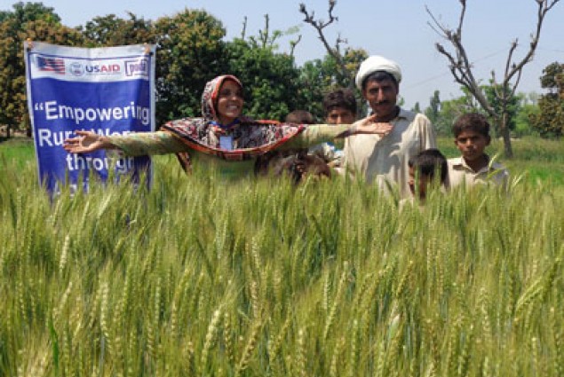 Nuzhat Bibi with her family at her wheat field