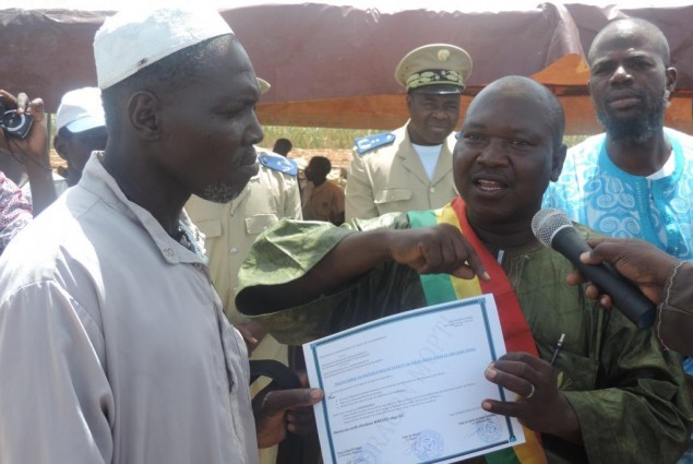 The Mayor of Sio handing certificate over to the cheif of the village of Wendeguele