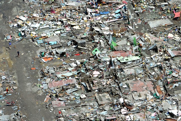 This aerial photo shows flattened houses in the city of Tacloban, Leyte province, in the central Philippines on November 11, 201