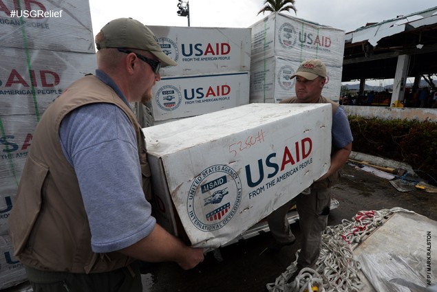 USAID staff prepare to load relief supplies into a US navy Seahawk helicopter at Tacloban Airport on November 17, 2013. 
