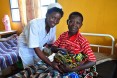 A nurse helps a new mother at a hospital in Rwanda