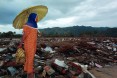 An Indonesian woman takes in the damage one day after a magnitude 9.0 earthquake produced deadly tsunami 