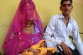 A father and mother with their newborn child in India